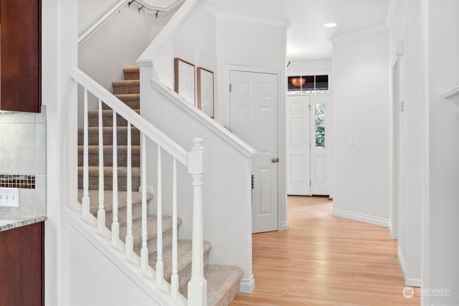 15929 36th Avenue Southeast Bothell, WA 98012 - Photo 13 of 33 a view of staircase with lots of frames on wall and wooden floor