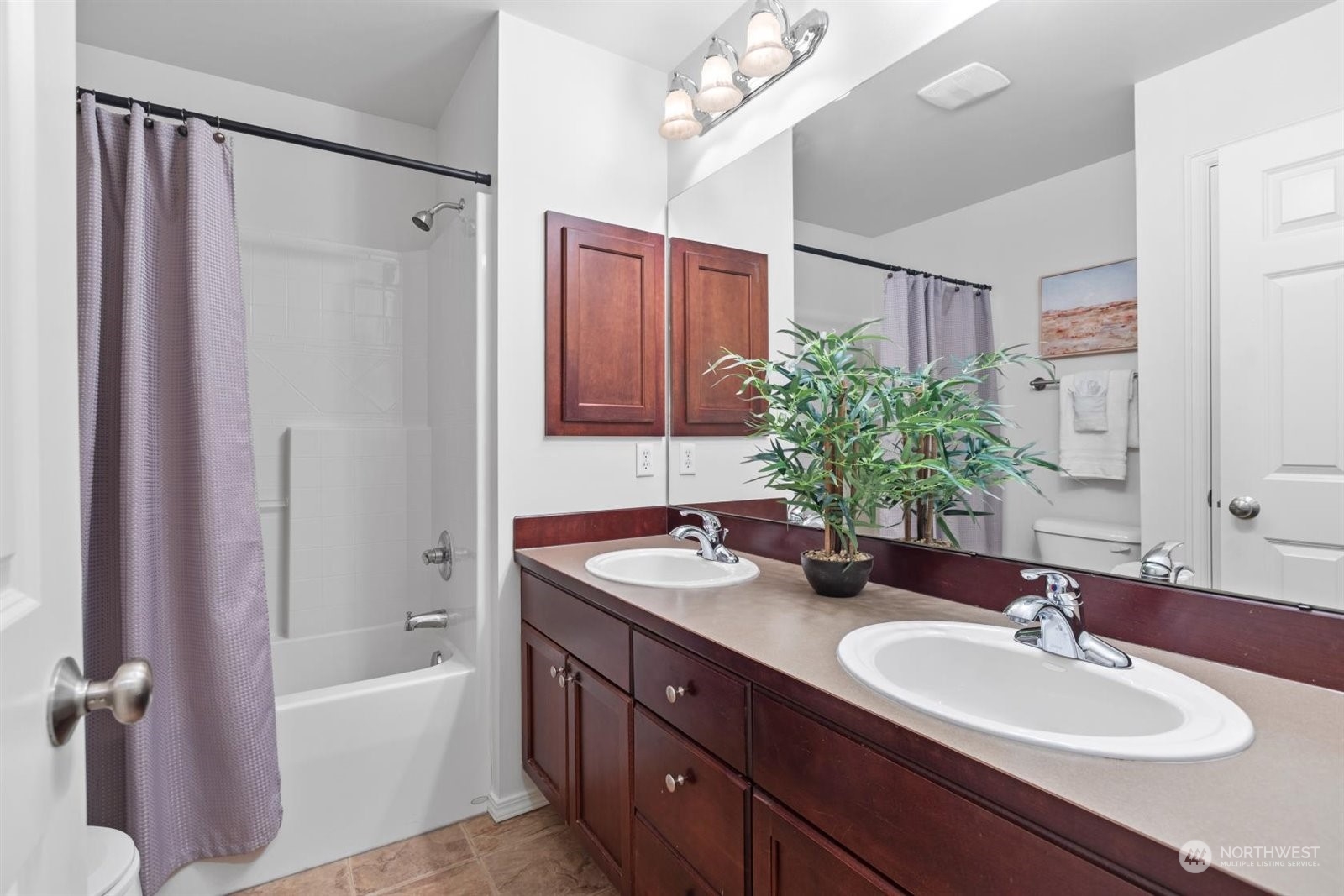 15929 36th Avenue Southeast Bothell, WA 98012 - Photo 23 of 33 a bathroom with a granite countertop sink a mirror a vanity and a bathtub