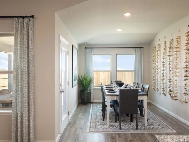 a view of a dining room with furniture and windows