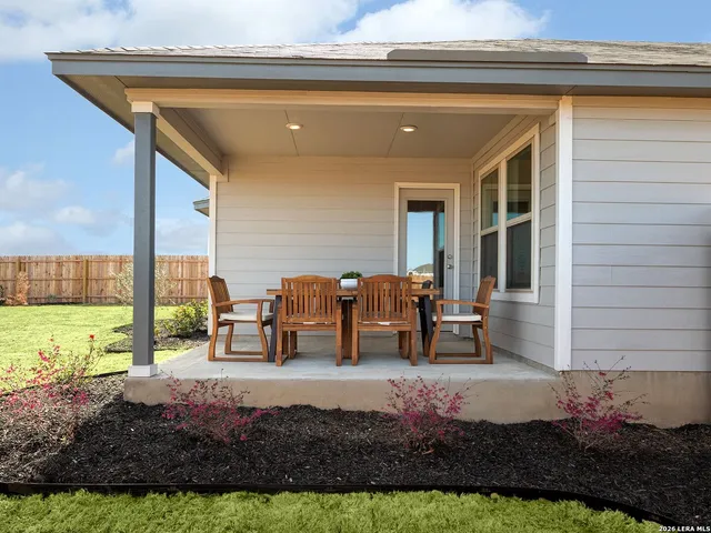 a view of a house with backyard porch and sitting area