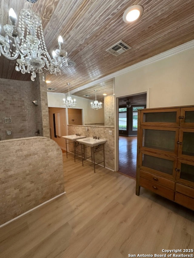 148 Robindale West Road Bandera, TX 78003 - Photo 14 of 24 a room with lots of wooden furniture and a chandelier