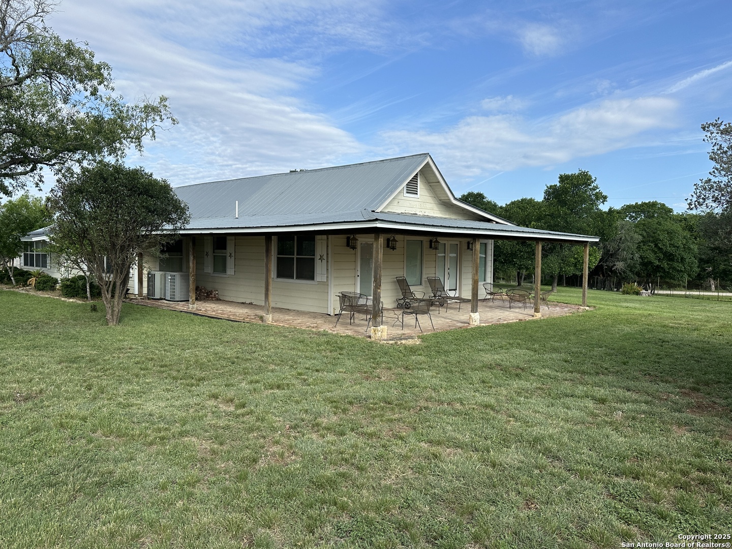 148 Robindale West Road Bandera, TX 78003 - Photo 22 of 24 a front view of a house with a yard
