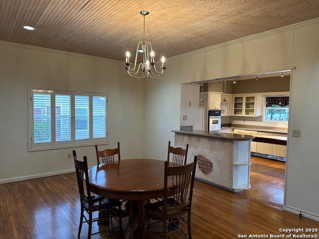 148 Robindale West Road Bandera, TX 78003 - Photo 4 of 24 a view of a dining room with furniture a chandelier and wooden floor