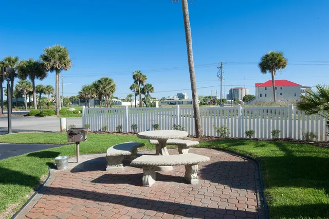 a view of a wooden door and chair in the patio