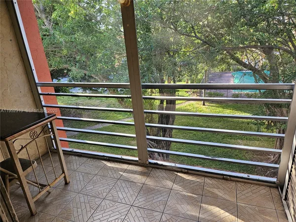 a view of outdoor space with deck and white door