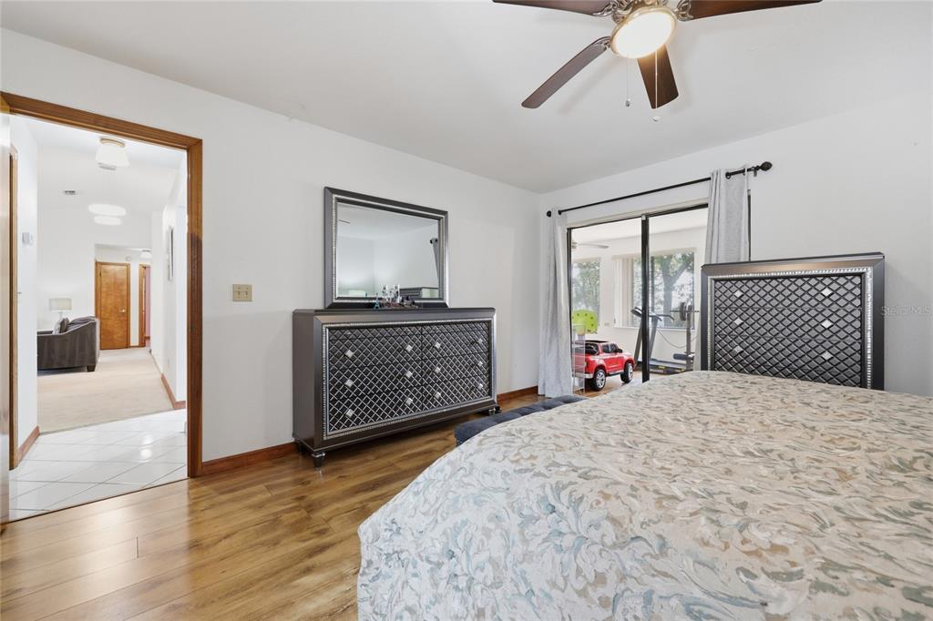 16104 Southwest 48th Circle Ocala, FL 34473 - Photo 20 of 34 a bedroom with a bed and wooden floor