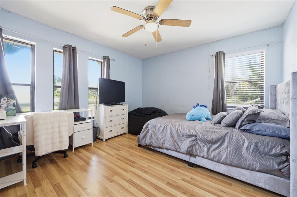 16104 Southwest 48th Circle Ocala, FL 34473 - Photo 24 of 34 a bedroom with a bed and a flat screen tv