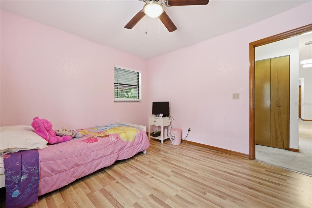 16104 Southwest 48th Circle Ocala, FL 34473 - Photo 26 of 34 a bedroom with a bed and wooden floor