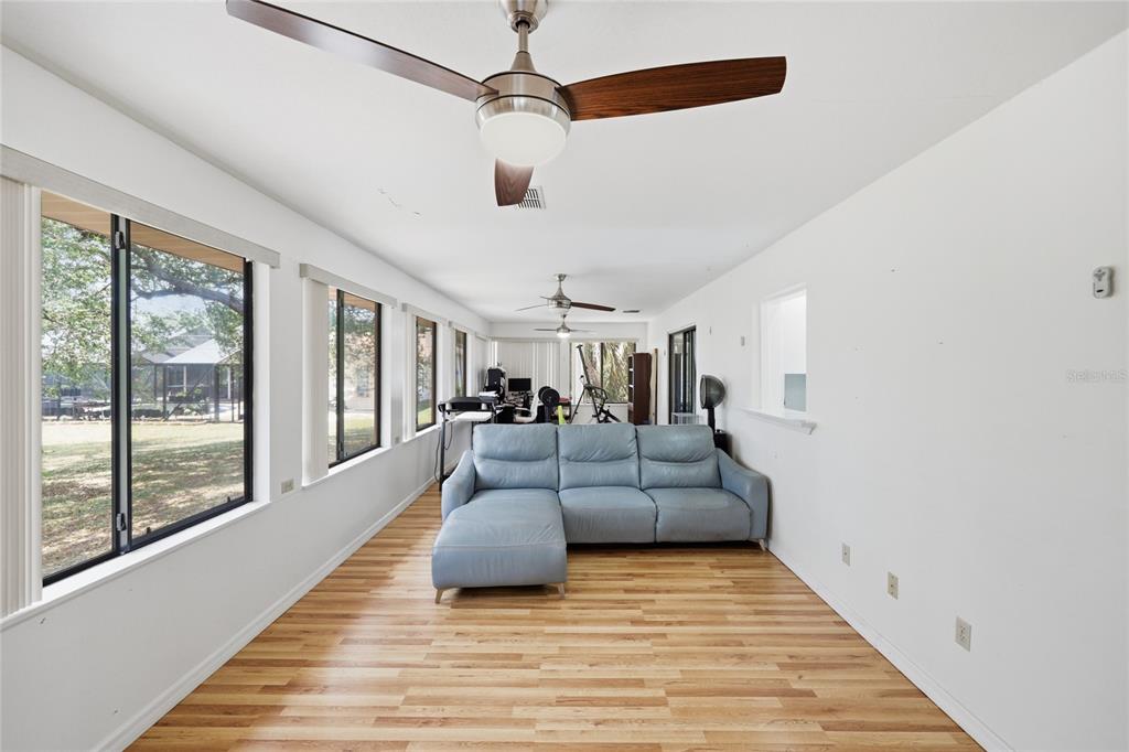 16104 Southwest 48th Circle Ocala, FL 34473 - Photo 28 of 34 a living room with furniture and a wooden floor