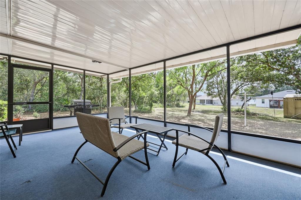 16104 Southwest 48th Circle Ocala, FL 34473 - Photo 32 of 34 a view of a city from a dining room with furniture and large windows