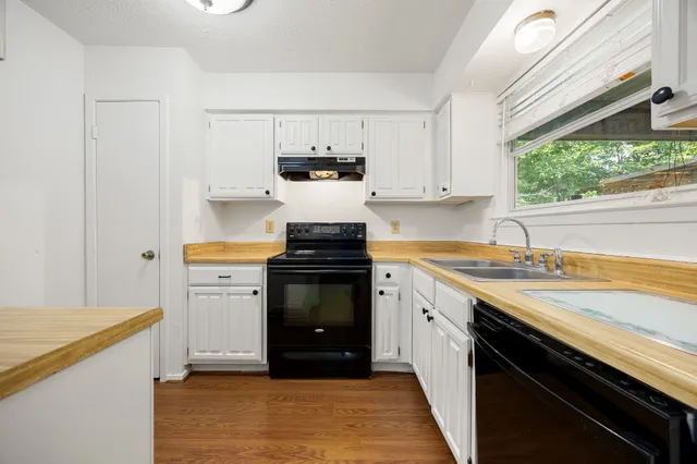 a kitchen with a sink stove and microwave