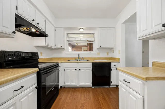 a kitchen with a sink stove and cabinets