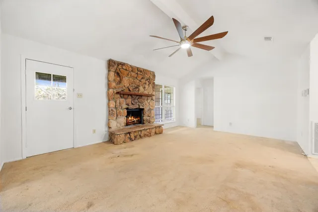 a view of empty room with a fireplace