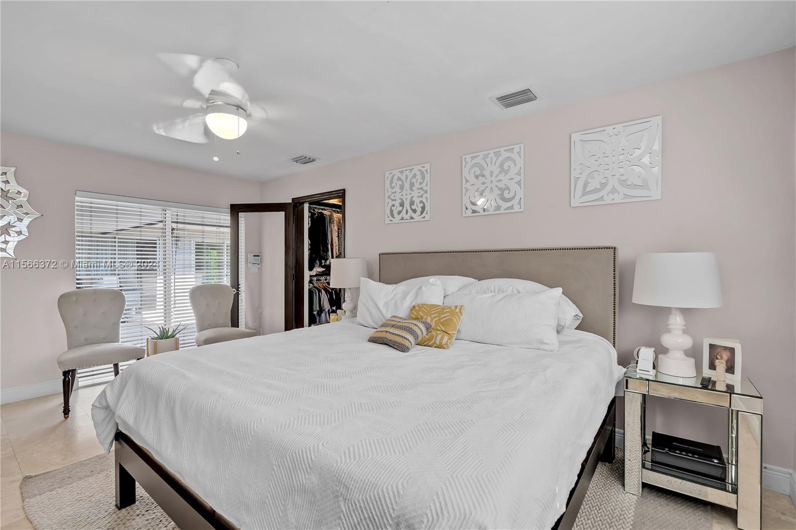 8341 Southwest 87th Terrace Miami, FL 33143 - Photo 15 of 31 a bedroom with a bed and window with chair
