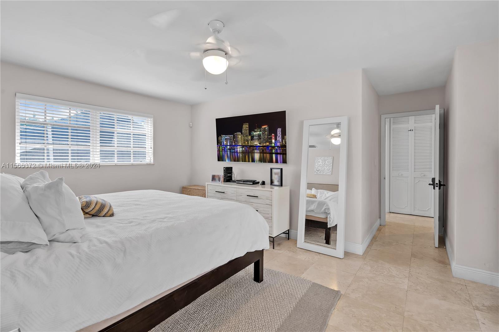 8341 Southwest 87th Terrace Miami, FL 33143 - Photo 16 of 31 a bedroom with a bed and a window