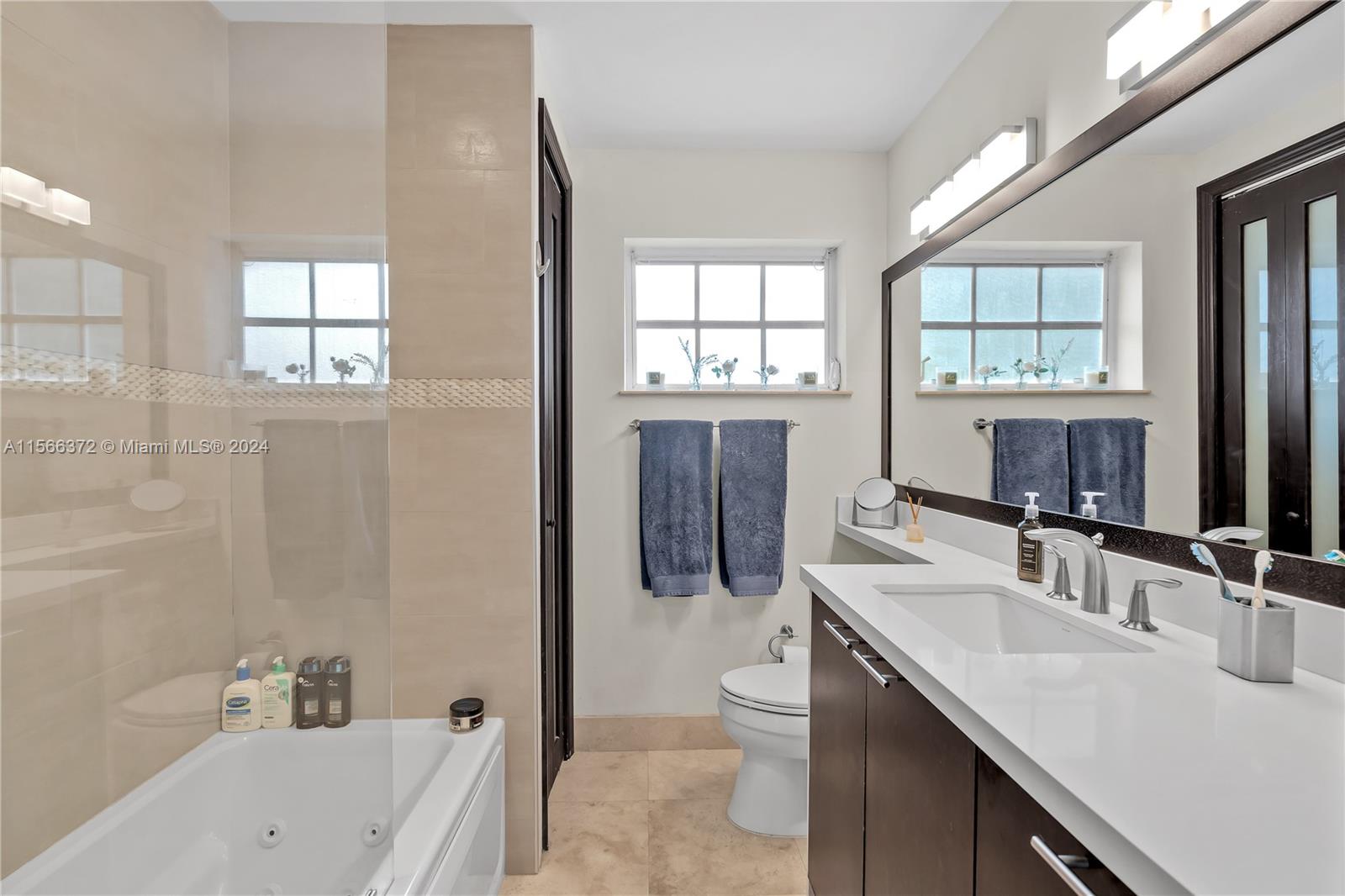 8341 Southwest 87th Terrace Miami, FL 33143 - Photo 17 of 31 a bathroom with a sink toilet and shower