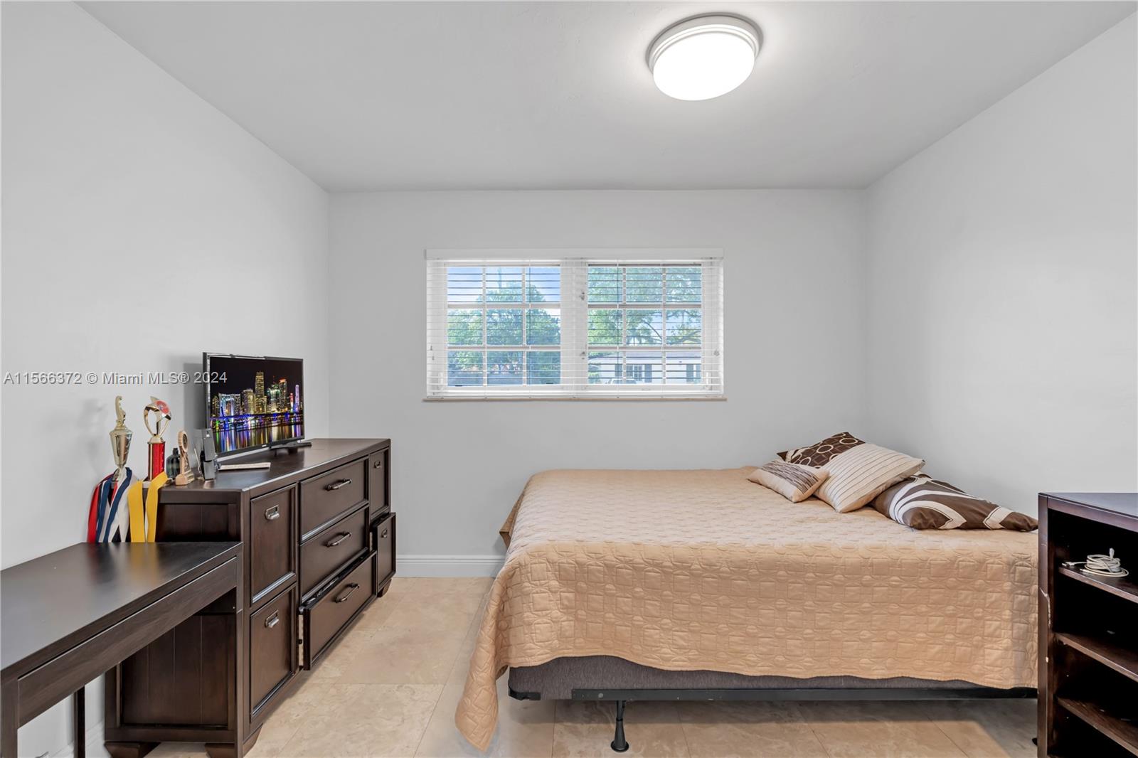 8341 Southwest 87th Terrace Miami, FL 33143 - Photo 20 of 31 a bedroom with a bed and a desk in it