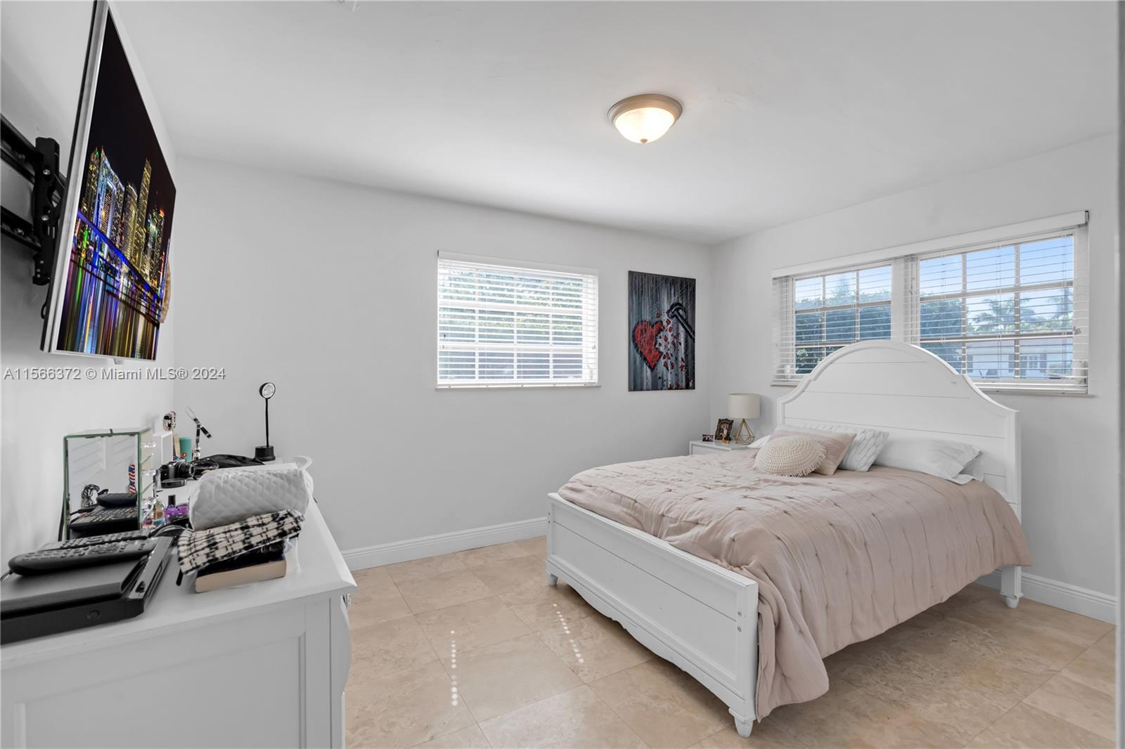8341 Southwest 87th Terrace Miami, FL 33143 - Photo 21 of 31 a bedroom with a bed and a window