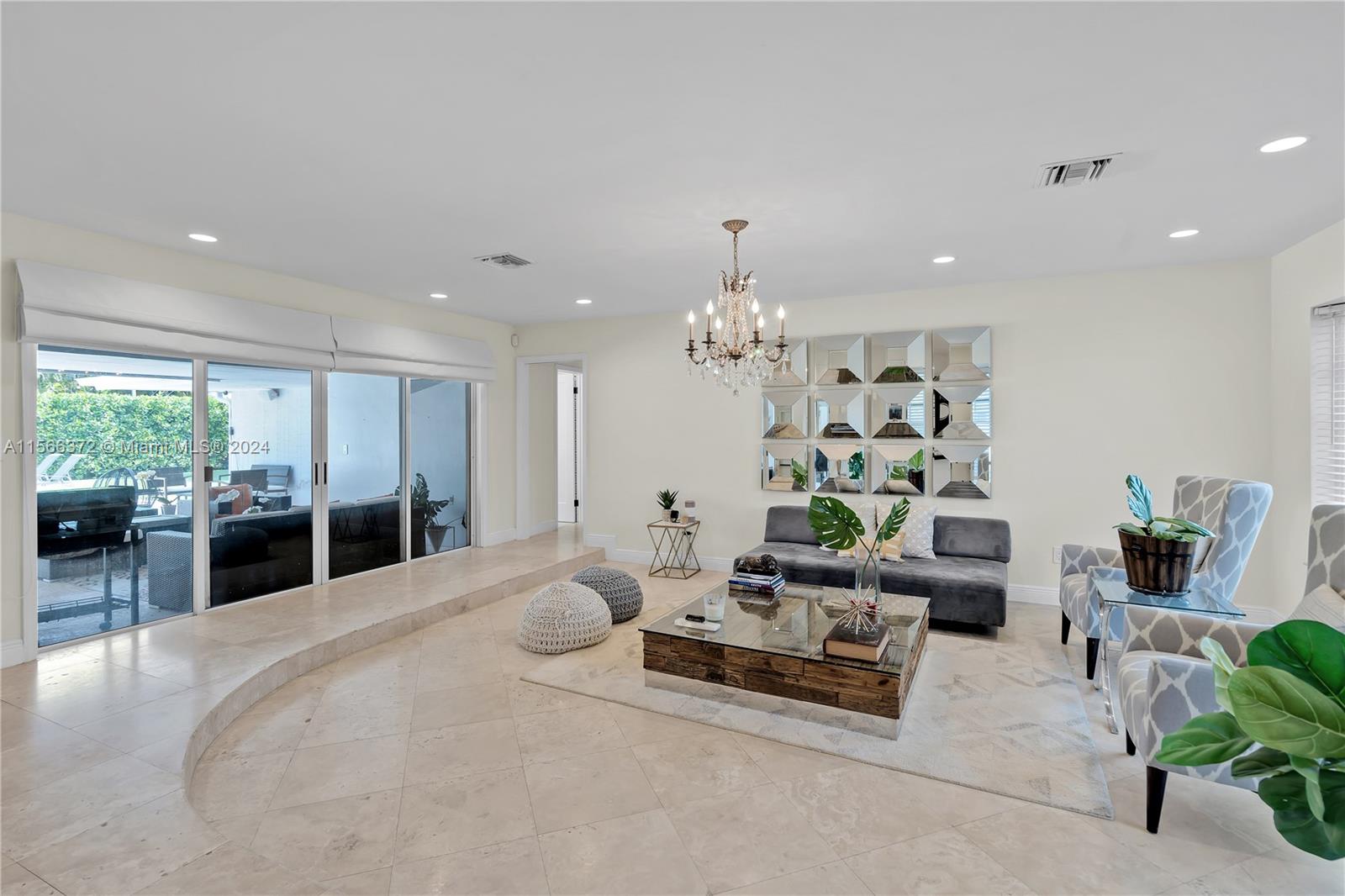 8341 Southwest 87th Terrace Miami, FL 33143 - Photo 5 of 31 a living room with furniture and a chandelier