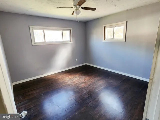 a view of wooden floor and windows in a room