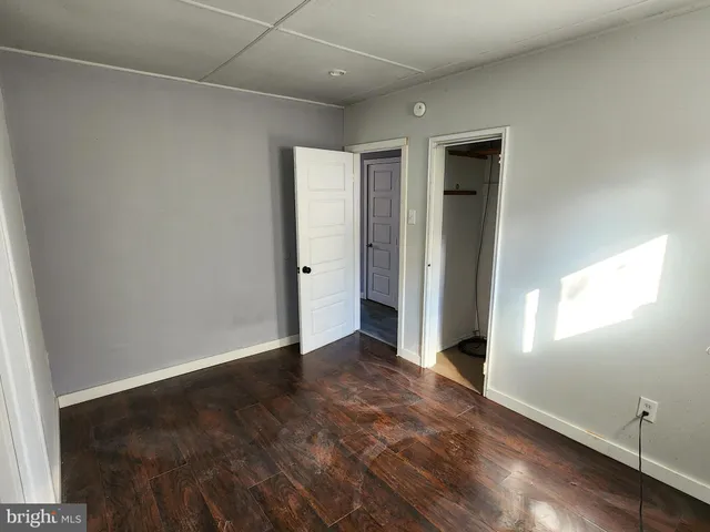 an empty room with windows and closet
