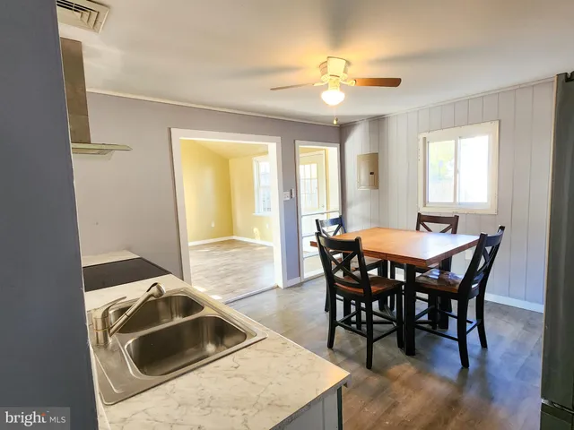 a view of a dining room with furniture and chandelier