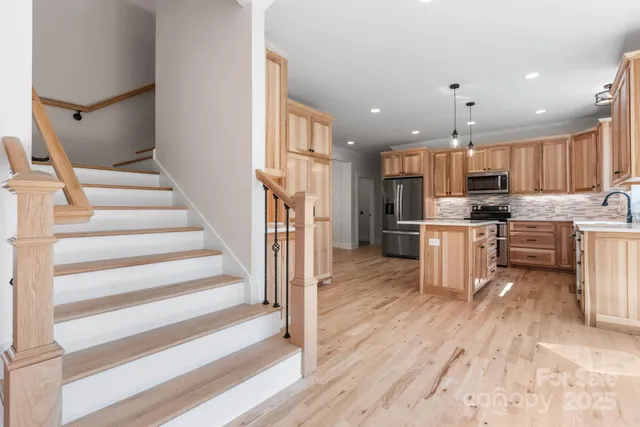 a view of kitchen with cabinets microwave and stove