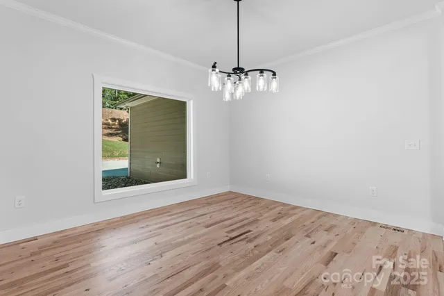 a view of a kitchen with a refrigerator a ceiling fan and wooden floor