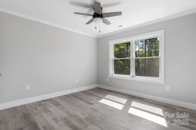 a bathroom with a granite countertop sink a mirror and shower