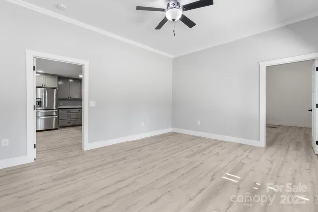 a view of an empty room with wooden floor