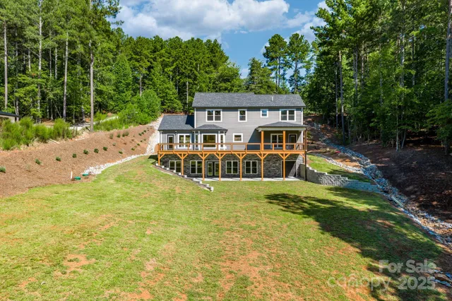 an aerial view of a house with a yard basket ball court and outdoor seating