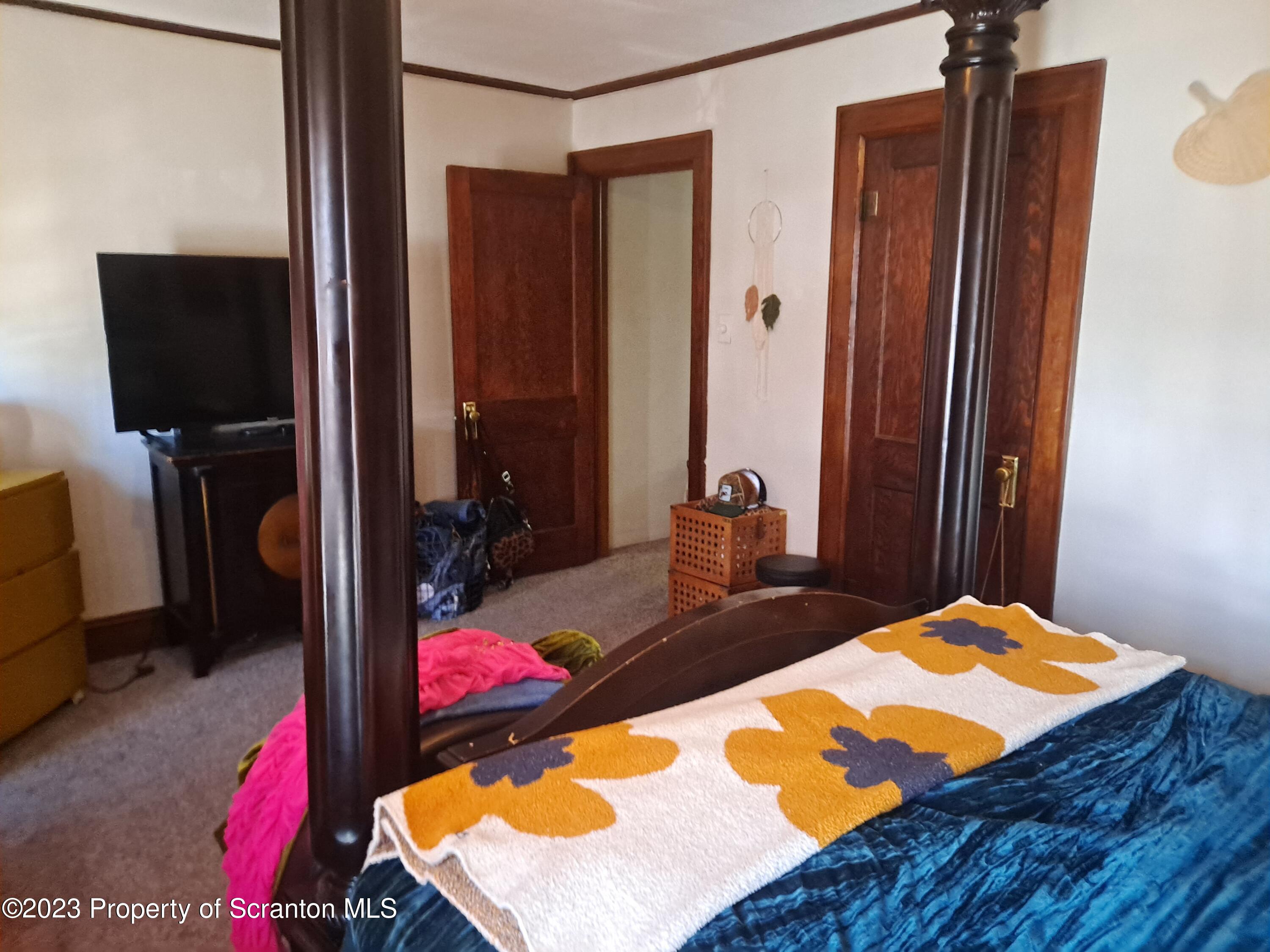 231 Putnam Street Scranton, PA 18508 - Photo 13 of 13 a bedroom with a bed dresser and a flat tv screen