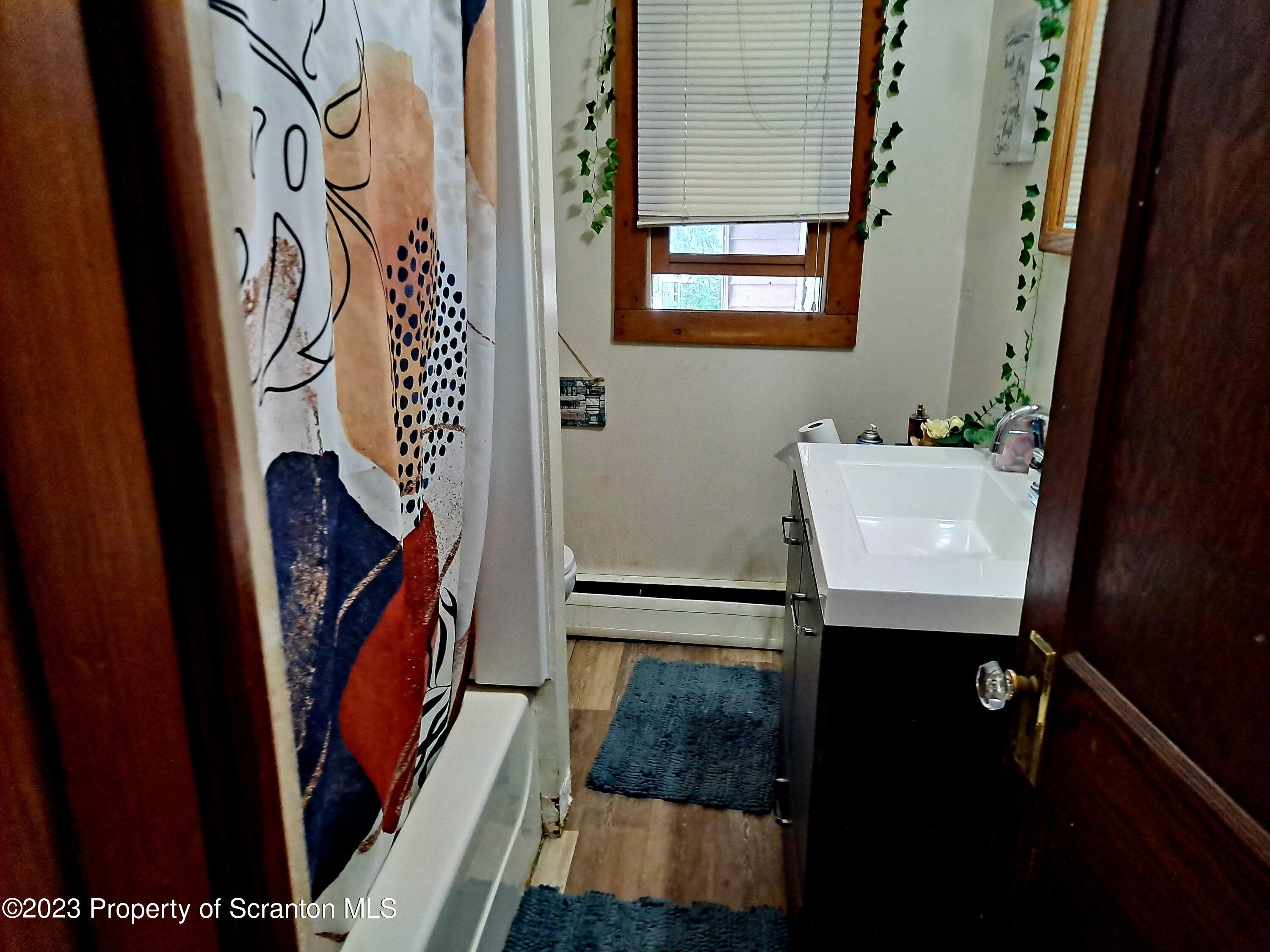231 Putnam Street Scranton, PA 18508 - Photo 10 of 13 a bathroom with a sink and a mirror