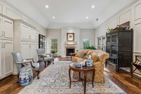 a living room with fireplace furniture and a wooden floor