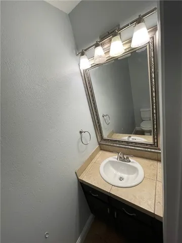 a bathroom with a sink and mirror