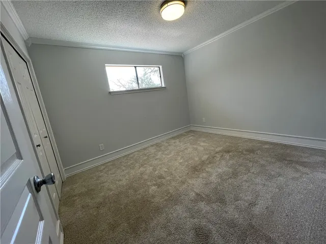 an empty room with windows and closet