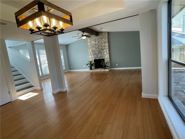 wooden floor in an empty room with a window