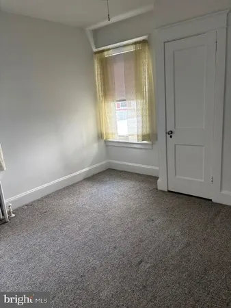 an empty room with a empty space and windows