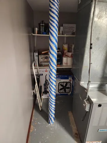 an empty room with wooden floor a fireplace and windows