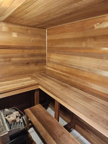 a bathroom with a granite countertop toilet sink and mirror