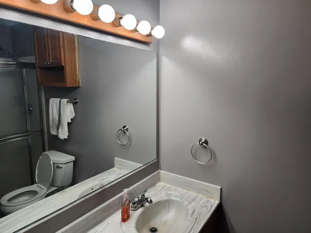 an empty room with wooden floor and closet