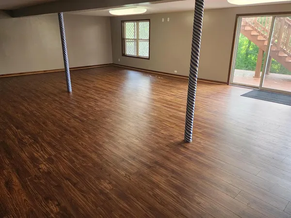 a view of entryway with wooden floor and a front door