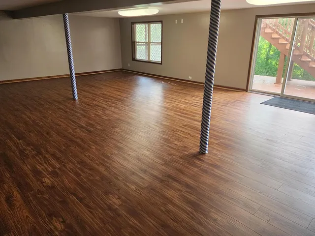 a view of entryway with wooden floor and a front door