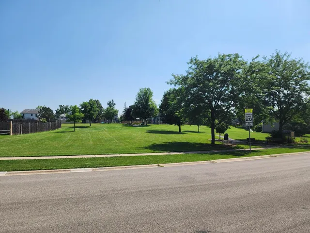 a view of a park and trees in the background