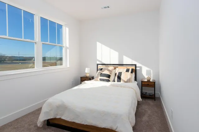 a bedroom with a bed and window