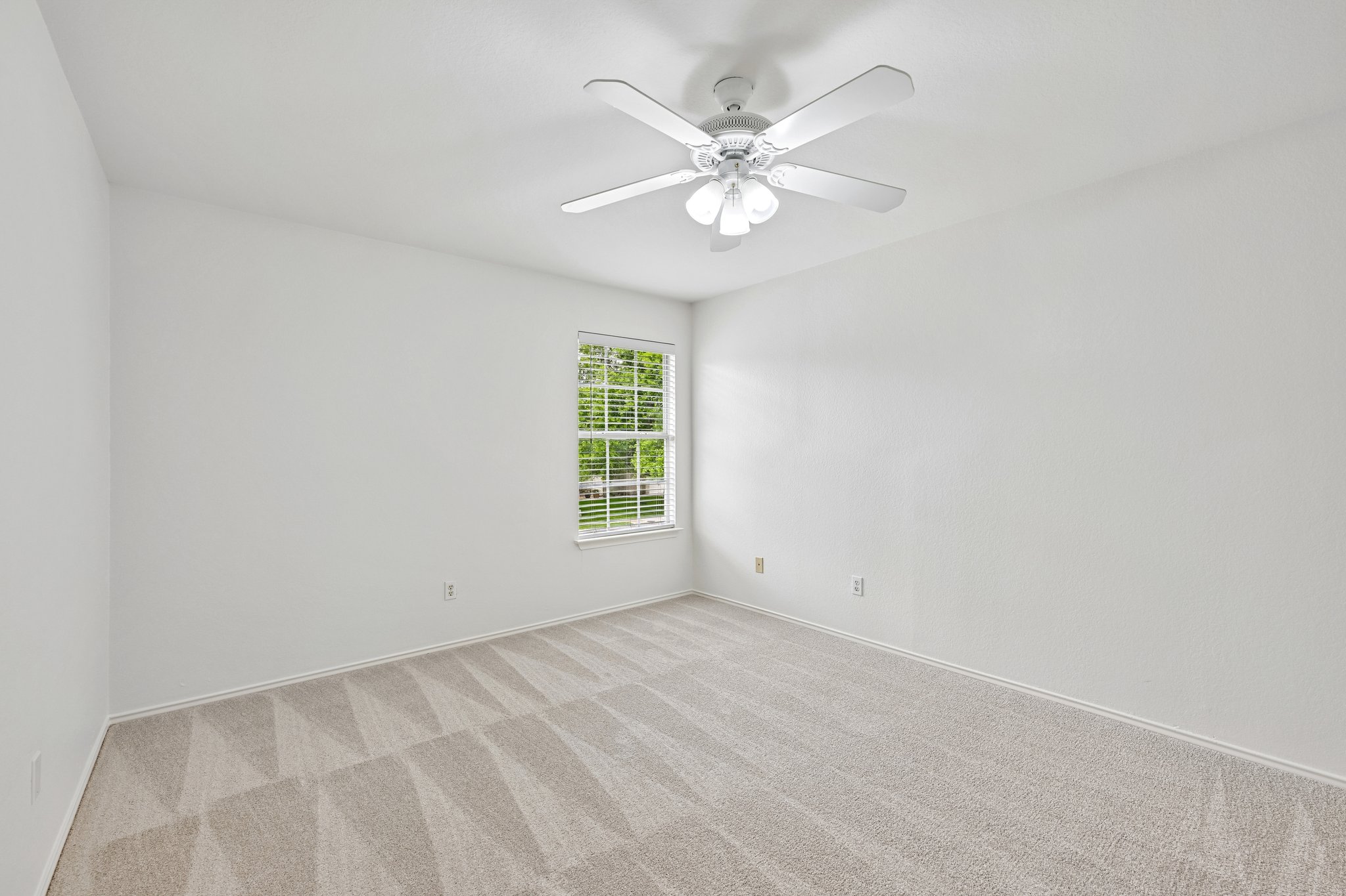4100 Mocha Trail Austin, TX 78728 - Photo 19 of 33 A well-lit bedroom with fresh carpeting and ample natural light from the window.