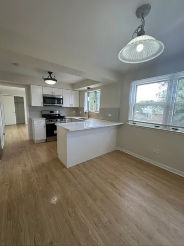 a view of a kitchen with a sink cabinets and a window