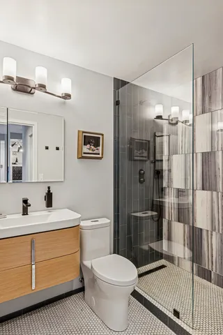 a living room with furniture and a painting on the wall