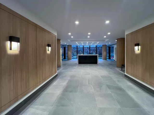 a view of a kitchen with a refrigerator and a window