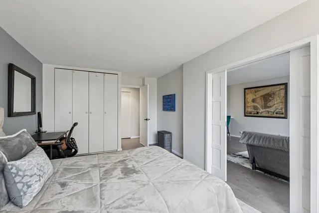 a bedroom with a bed a table and chair